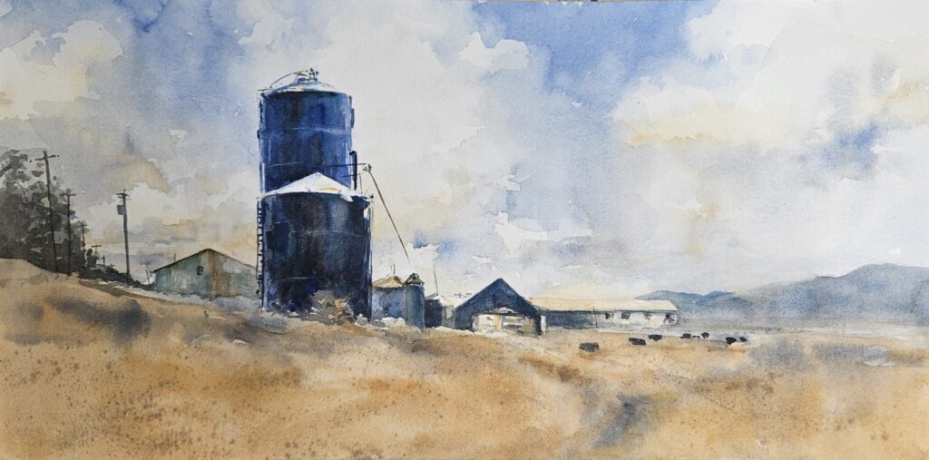 rural landscape of cows and blue silo
